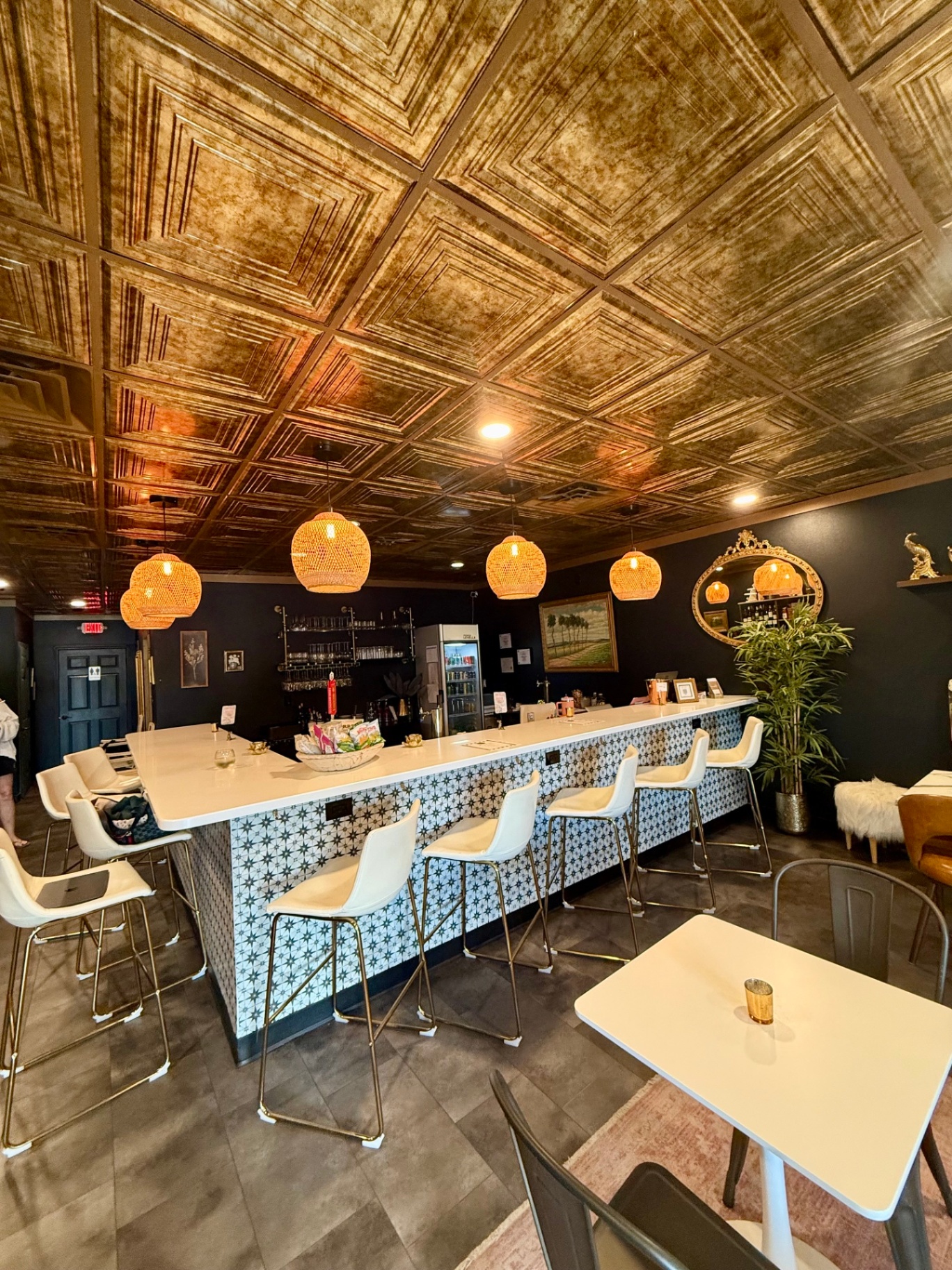 The candlelit dining room at Cork + Table with its copper hammered-tin ceiling