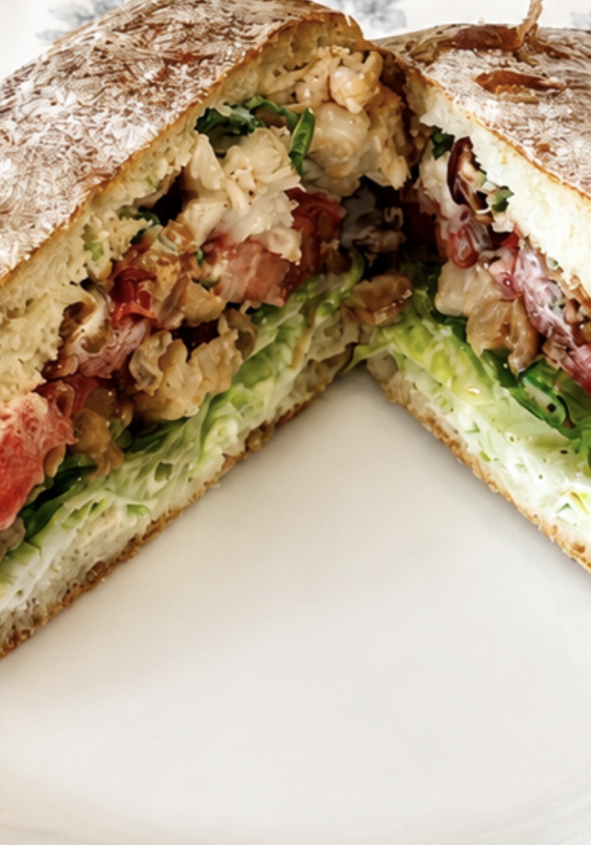 A Lobster BLT with buttery lobster, crisp bacon, lettuce and tomato